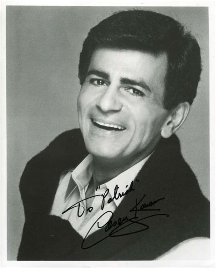 Casey Kasem is on a tuxedo whereas, Jean Kasem is wearing a pink dress with flowers on it.