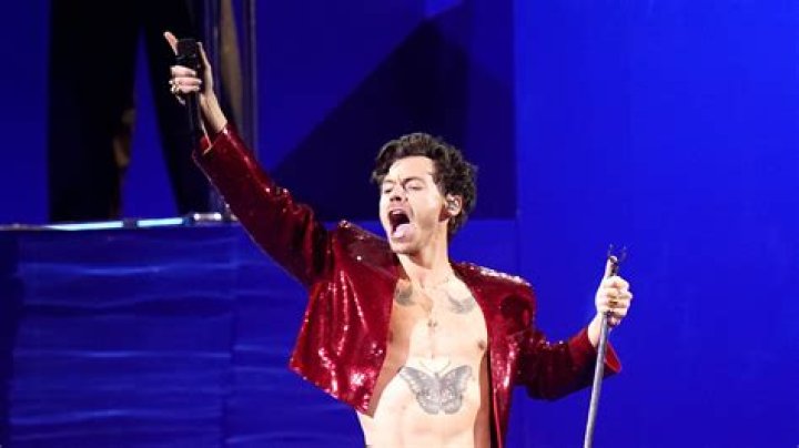 Harry Styles performing on the stage.