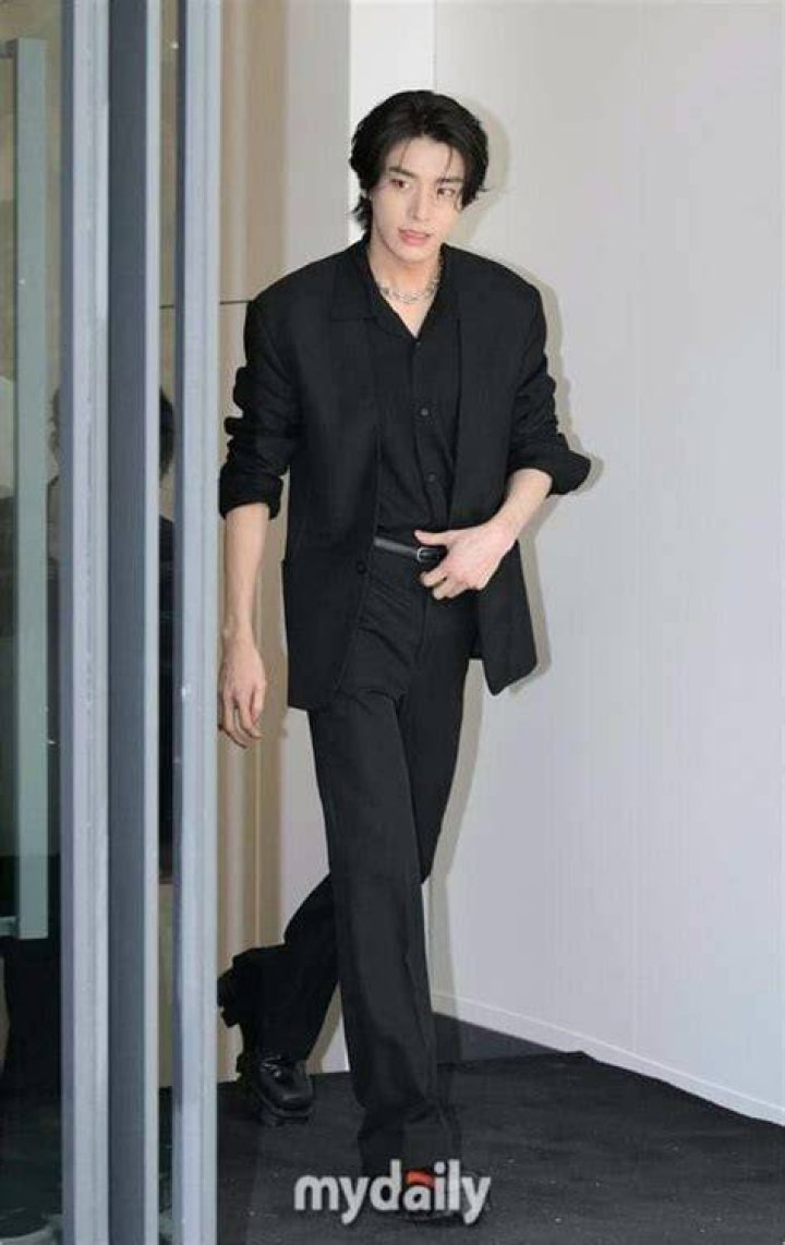 Jake is wearing completely black. He is wearing black suit, black shirt, black pant.