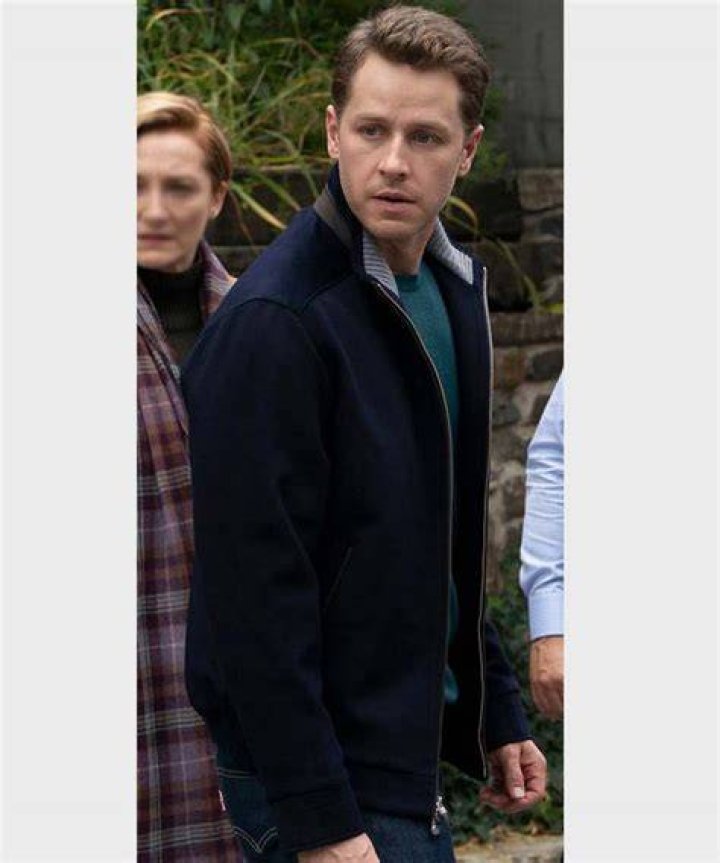 Josh Dallas in a blue denim shirt posing with his wife Ginnifer Goodwin in a red and black checked tops.