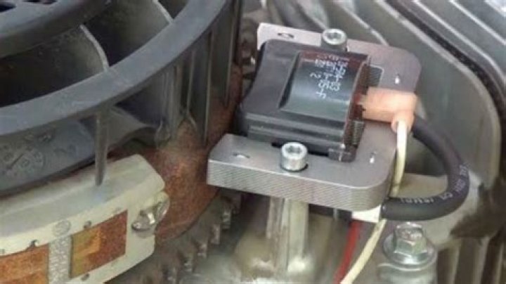 What does the ignition coil do on a lawn mower?